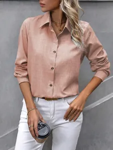 Détail d'une chemise rose décontractée à manches longues pour femmes avec col rabattu