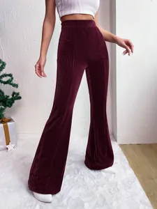 Detailed view of high-waisted burgundy corduroy flare pants showing fabric texture.