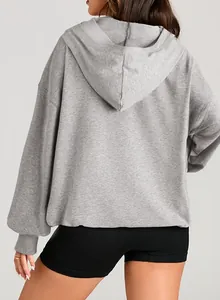 Back view of a grey oversized hooded sweatshirt featuring a casual and loose fit