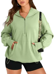 Close-up of women's sage green quarter-zip hoodie with front pocket and drawstring hem.