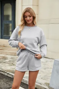 Casual two-piece set featuring a grey sweatshirt and drawstring shorts with pockets