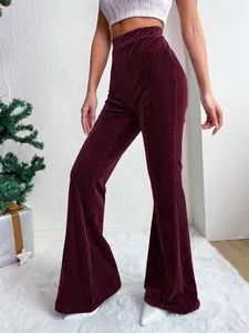 Detail showing the rich texture of high-waisted corduroy flared pants in deep burgundy