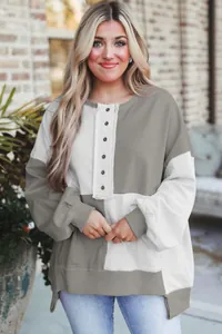 Women's chic color-block sweatshirt featuring a button placket and stylish side slits