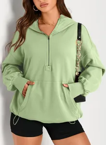 Close-up detail of women's sage green oversized half-zip hoodie with front pocket.