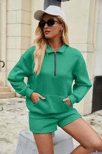 Modisches grünes zweiteiliges Sweatshirt- und Shorts-Set, getragen von einem Model im Freien.