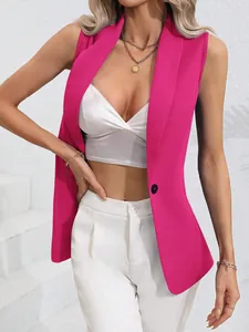Detailed view of a vibrant fuchsia sleeveless blazer with a single black button.
