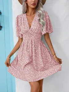 Detail view of pink V-neck floral mini dress with flutter sleeves and high waist