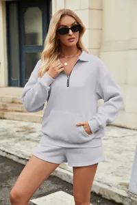 Lifestyle-Outdoor-Ansicht eines grauen Damen-Half-Zip-Sweatshirts und Shorts-Sets