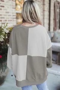Back view of a casual color-blocked sweatshirt with grey and light beige spliced panels