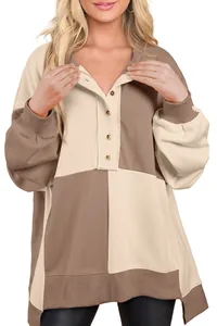 Detailed view of color-block sweatshirt with button-up collar and ribbed cuffs