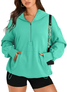Detailed view of mint green women's quarter-zip hooded sweatshirt with front pocket