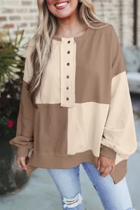 Detail view of a casual color-block patchwork long-sleeve sweatshirt with buttons.
