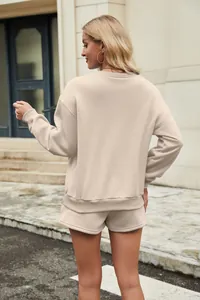 Back view of women's beige long sleeve sweatshirt and matching shorts two-piece set