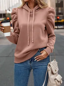 Close-up of a dusty rose hooded sweatshirt with stylish puff sleeves and drawstring detail