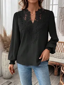 Detail shot of elegant black long sleeve blouse featuring V-neck lace and Swiss dots