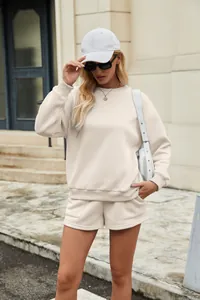 Outdoor street style view of beige sweatshirt and shorts lounge set for women