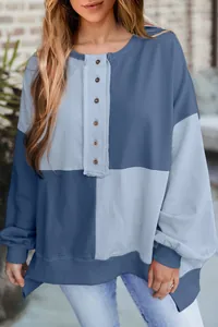 Front detail of a women's blue color-block buttoned oversized sweatshirt with drop shoulder