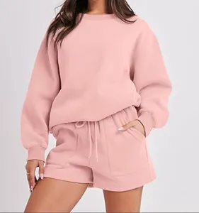 Close-up of pink two-piece loungewear set with sweatshirt and drawstring shorts.