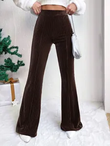 Detail view of high-waist brown corduroy flared pants with ribbed texture and wide leg