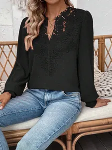 Detail of black V-neck top with intricate lace crochet neckline and swiss dot fabric texture
