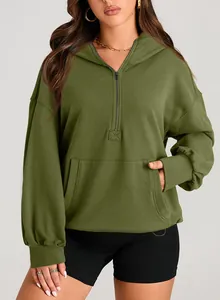 Detail view of olive green hooded sweatshirt with half-zip and front pocket.