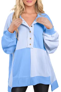 Detail of blue and white color block sweatshirt with button-down lapel