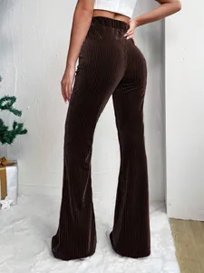 Detail view of brown high-waisted corduroy flare pants showing texture and fit.