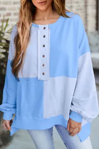 Detailed view of a casual color-block oversized sweatshirt with button placket detail