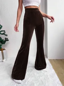 Close-up detail showing the rich texture of high waisted dark brown corduroy flare pants.
