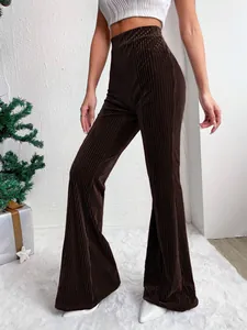 Detail of high-waist dark brown corduroy flare pants with vertical ribbed texture.