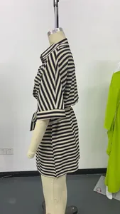Detailed side view of a black and white striped romper featuring a lapel collar and waist belt