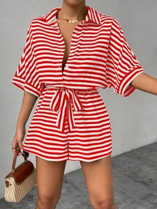 Close-up detail of a red and white striped collared romper with waist tie and button front