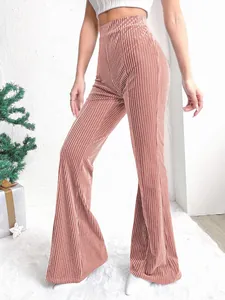 Detail of high-waisted dusty rose corduroy flare pants with vertical ribbed texture.