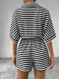 Back view detail of a black and white horizontal striped short romper for women.