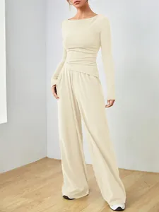 Elegante set due pezzi crema con maglia a maniche lunghe e pantaloni a gamba larga.