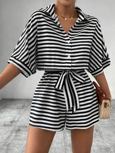 Elegant black and white striped button-down romper with waist tie and collar details