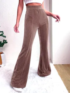 Detail view of brown high-waist corduroy flare pants featuring vertical ridges.