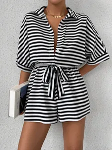 Close-up of black and white striped romper with button-up front and belted waist