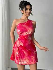 Detail of pink tie-dye one-shoulder mini dress with waist cutout and pleated skirt