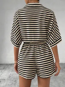 Detail view from the back of a women's black and beige striped lapel shirt and shorts set