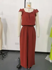 Macro view of rust red sleeveless jumpsuit with ruffle shoulders and square neckline