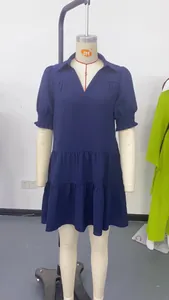 Detailed view of a navy blue tiered V-neck mini dress with elegant pleated puff sleeves