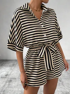 Detail view of stylish black and white striped short sleeve shirt and belted shorts set
