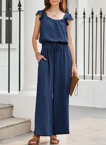 Detail view of navy blue ruffled sleeveless jumpsuit with textured fabric and wide legs