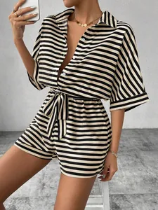 Detailed view of a black and white striped romper featuring a lapel collar and waist tie