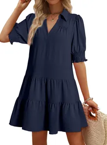 Detail view of navy blue V-neck tiered dress with smocked short sleeves