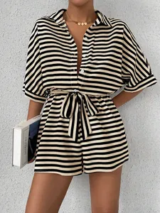 Stylish black and white striped button-up romper with adjustable waist tie belt