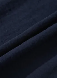 Close-up of navy blue linen-textured fabric with pleated detail for women's dress