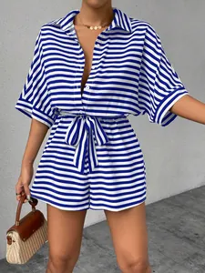 Close-up of blue and white striped belted romper with button-down lapel collar design
