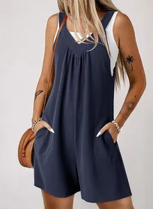 Detail of navy blue waffle-knit sleeveless jumpsuit with side pockets and V-neckline.